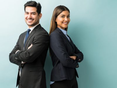 Latin confident professionals in suit standing against isolated background